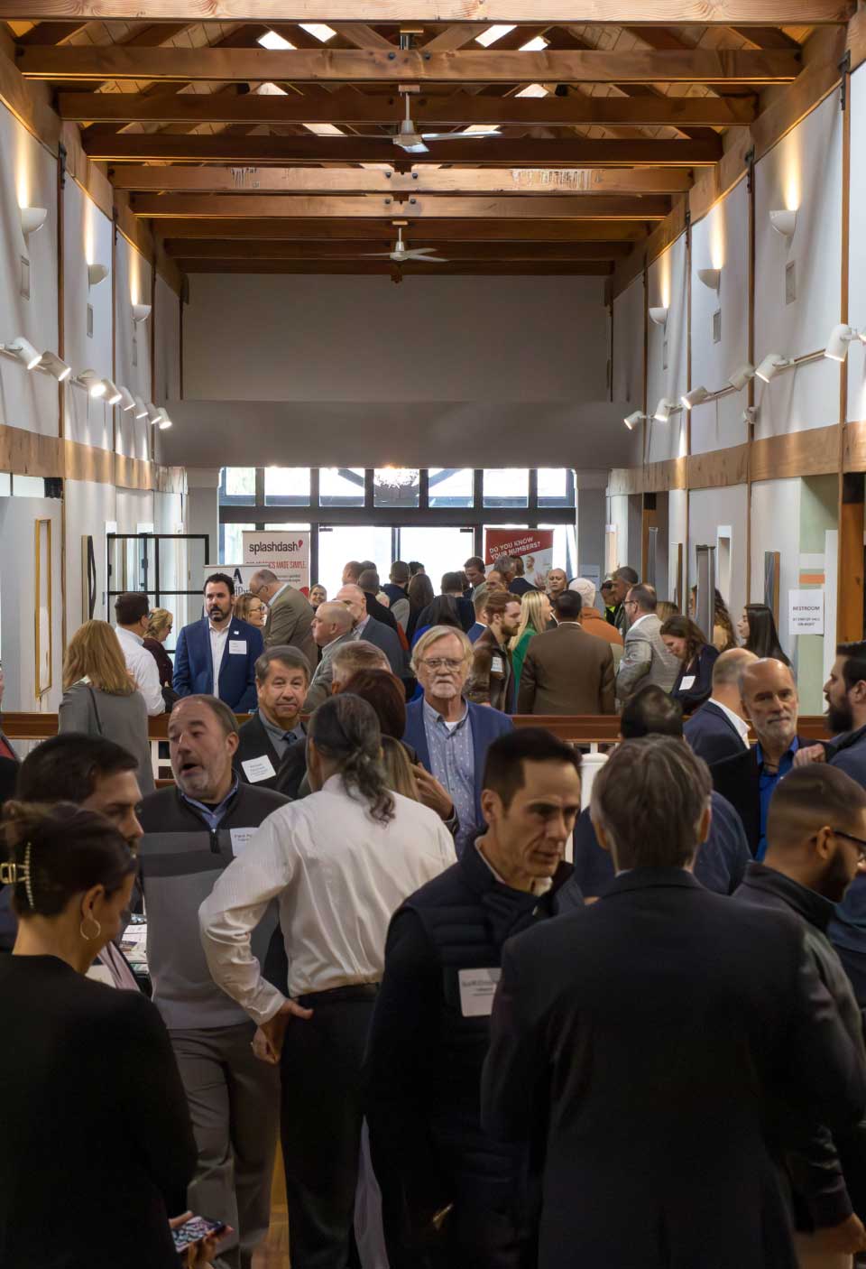 image of the upstairs hallway at rebellion group, a group of people filling the hallway during an event